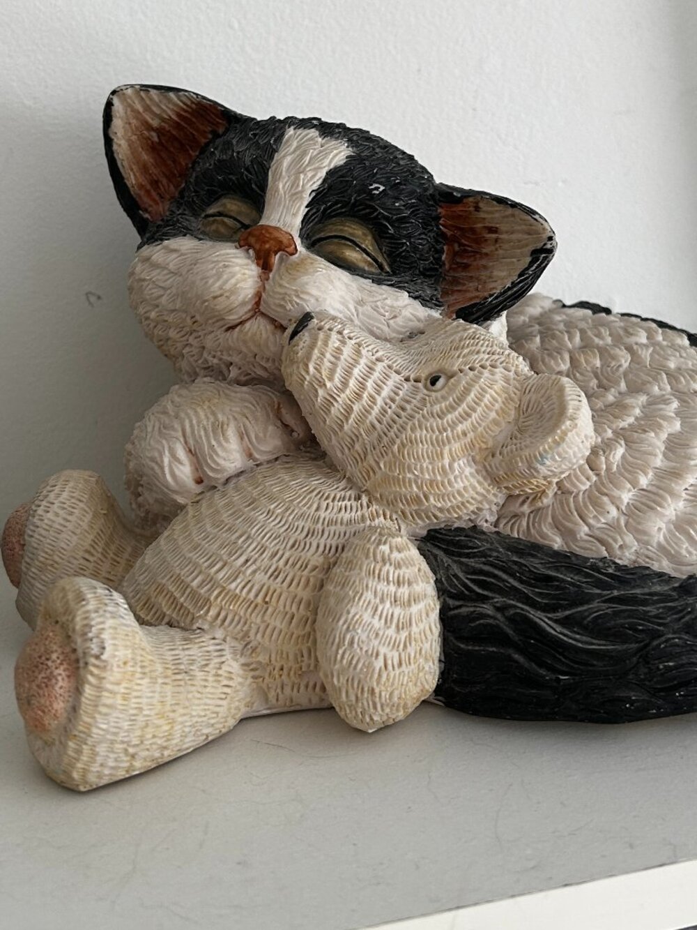 Black and White Kitten hold Teddy Bear